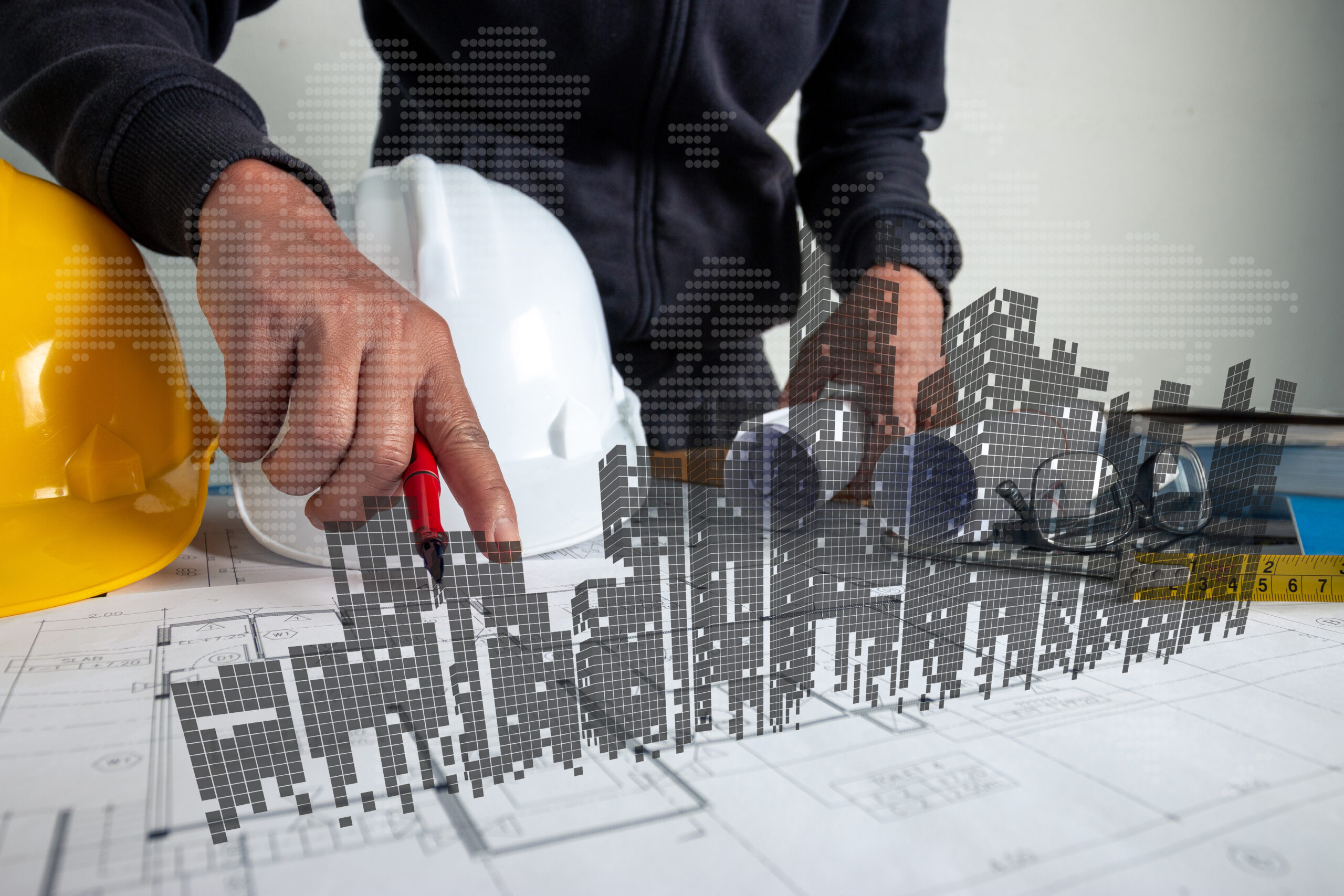An architect or engineer is working on a desk with architectural and engineering blueprints together with high-rise 3D images.